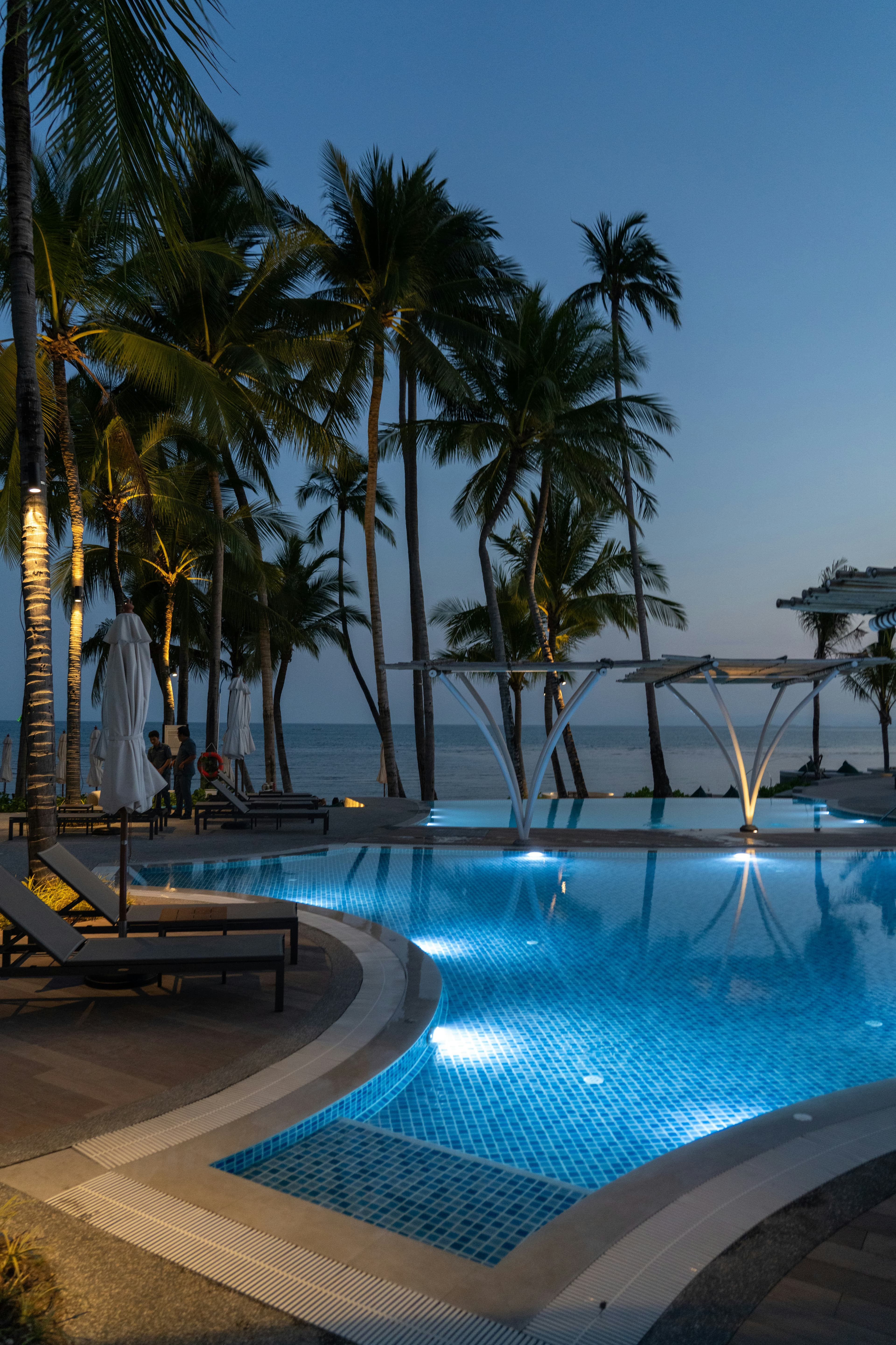 Luxury estate exterior with pool at twilight